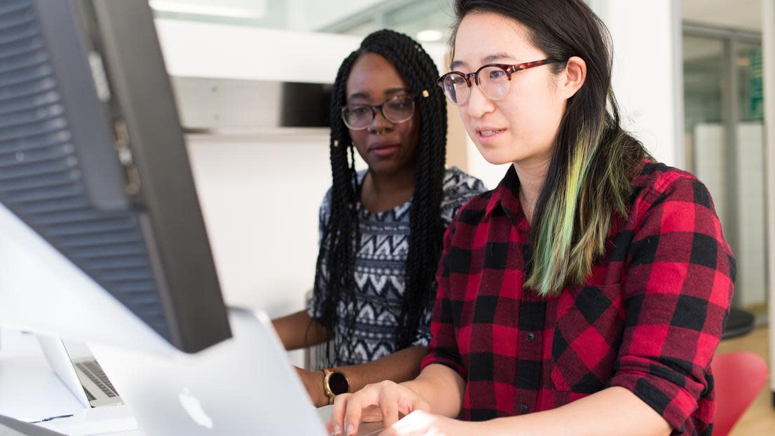 Sociology graduates working on a computer