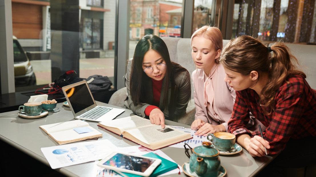 English students preparing a report together 