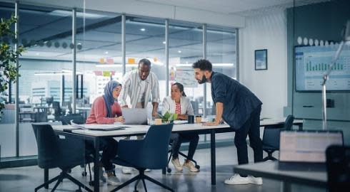 A marketing team working in an office around a table