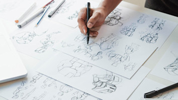 Hand sketching animation ideas on storyboard