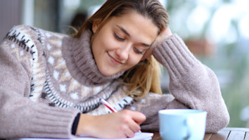 Student taking notes in winter - Credit: Antonio Guillem - Stock photo ID:1396316824 