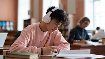 Teenage boy in a library revising