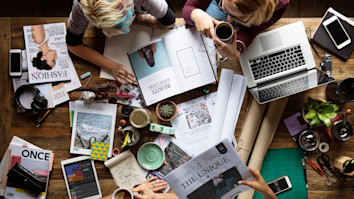 Publishing colleagues together teamwork working in office on magazine