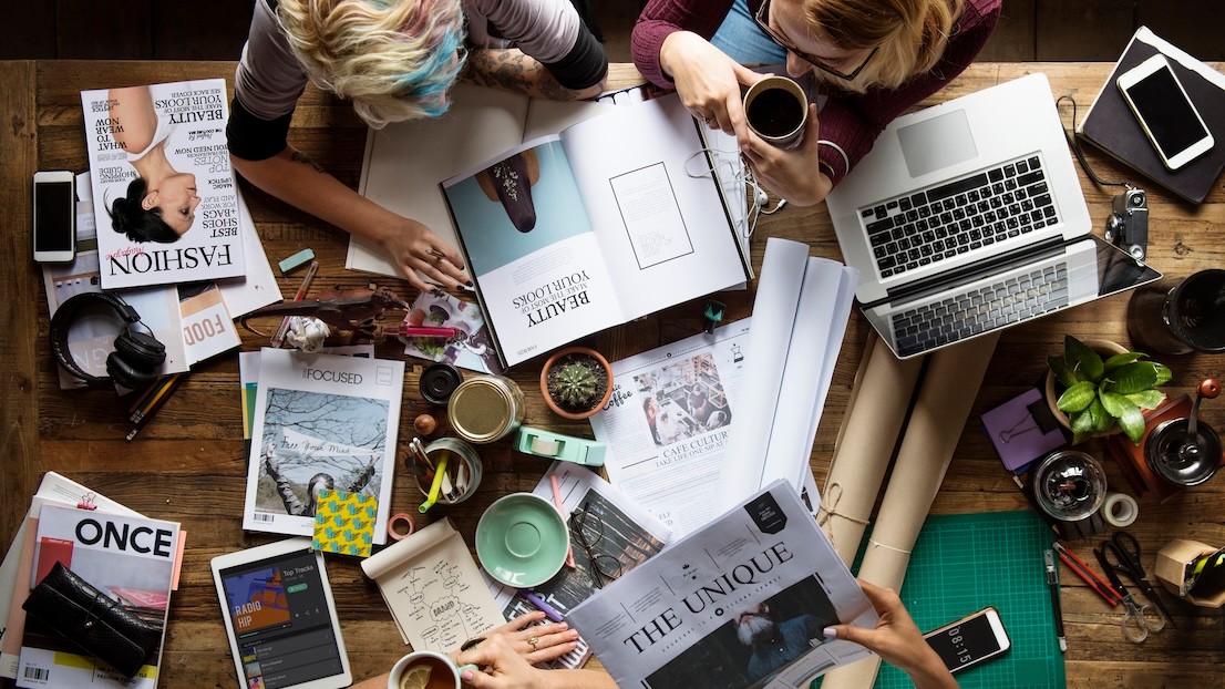 Publishing colleagues together teamwork working in office on magazine