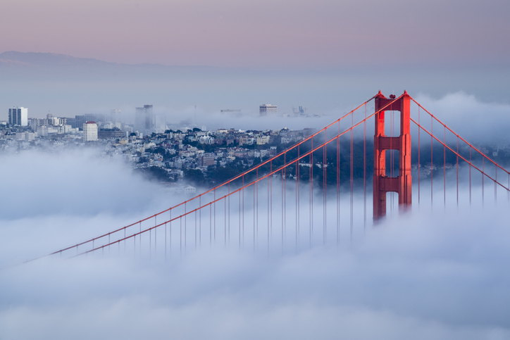 Golden Gate at dawn surrounded by fog