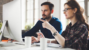 Two people discussing postgraduate study options