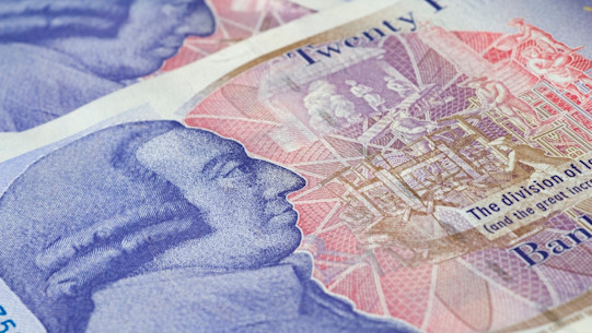 Close up of the back of a new British twenty-pound note showing Adam Smith's head