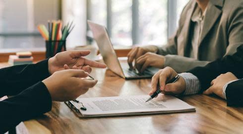 Lawyers looking at a contract.