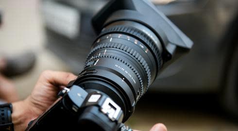 Close up of a DSLR camera held by a photography student
