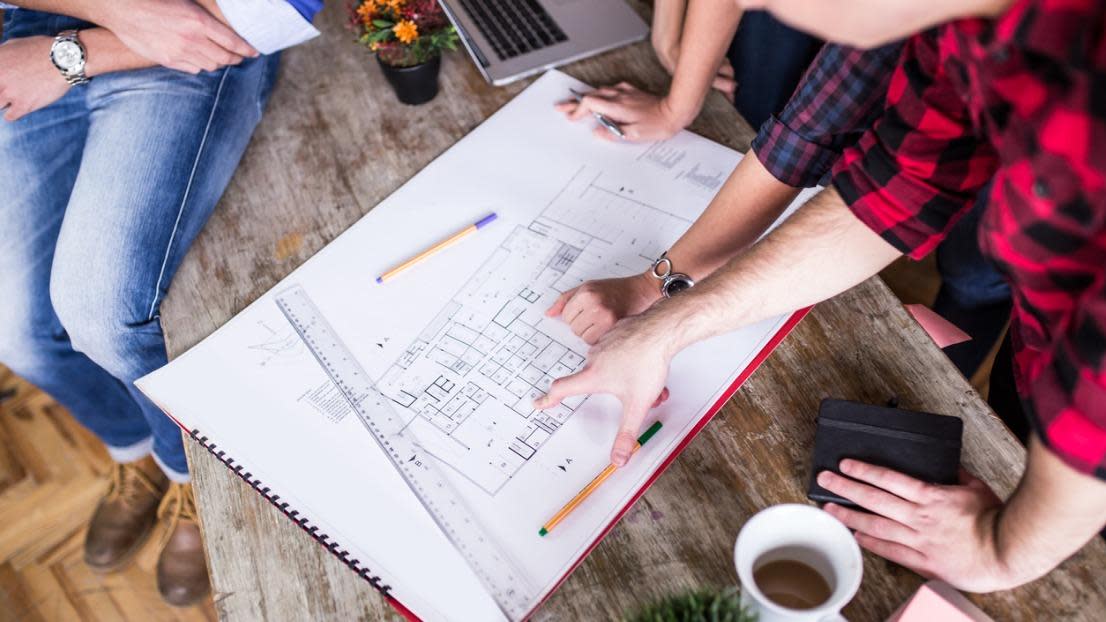 Four young architects working on a project
