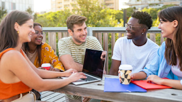 Cheerful group of friends studying for exams