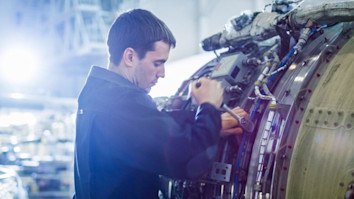 Aircraft Maintenance Mechanic Inspecting and Working on Airplane Jet Engine