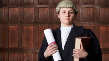  Female Lawyer In Court Holding Brief And Book