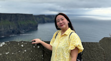 Aom Sornkaew stands in front of the rocky Cliffs of Moher on Ireland's southwest coast