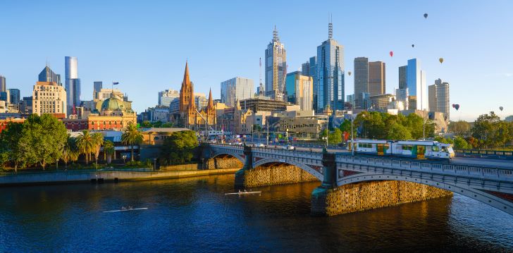 View of skyscrapers in Melbourne with bridge and river in the foreground
