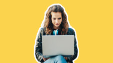 A woman using a laptop to write her personal statement