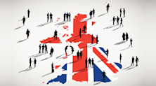 Graphic representing jobs in the UK, with the Union Flag overlaid on a map of the country. Many people walk around the map, talking and doing business in silhouette.