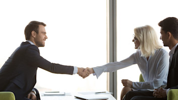 Two people businessmen shaking hands