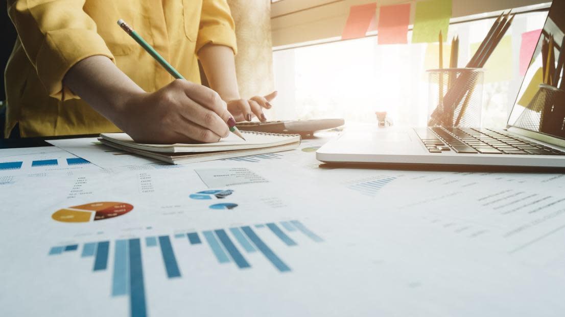 A woman using laptop computer to analysis data report
