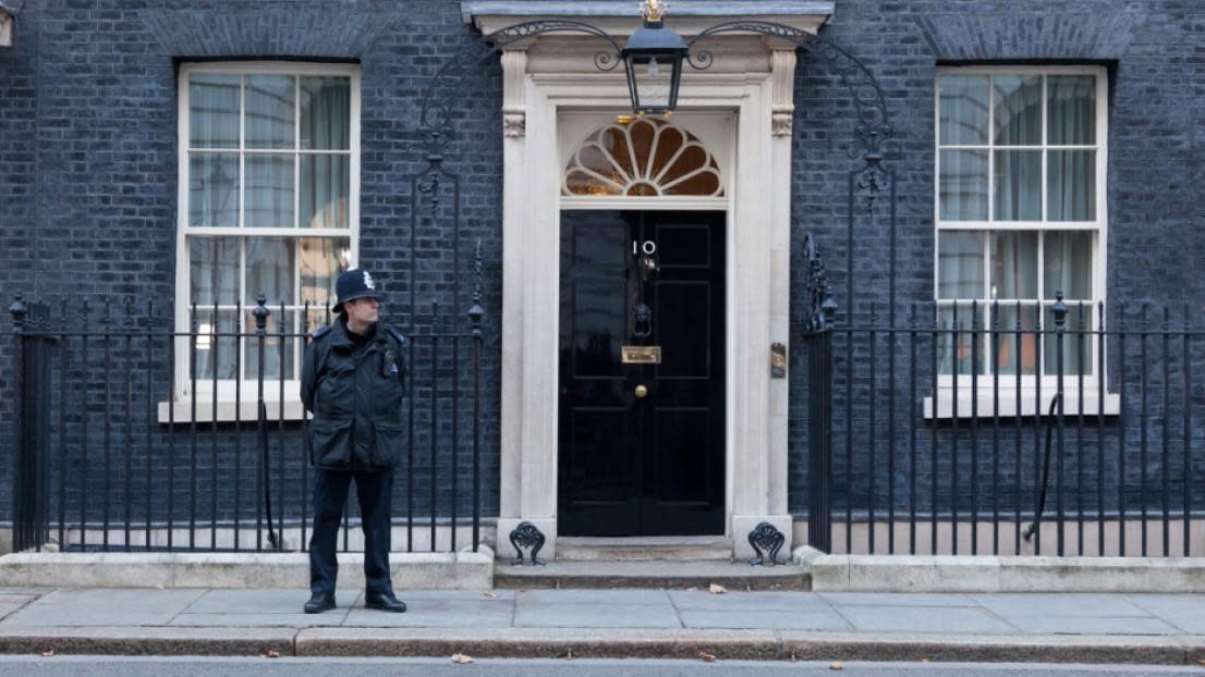 Guard standing outside 10 Downing Street door