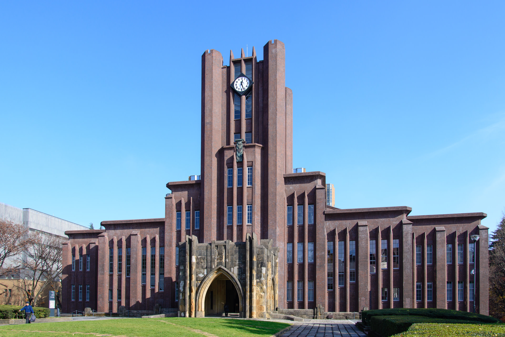 The brown brick exterior of Yasuda Auditorium at Japan's University of Tokyo, with its clock tower at the centre.