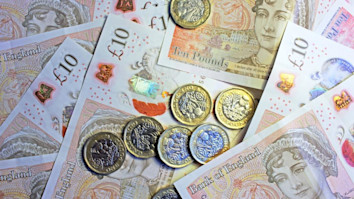 Close-up of pound coins on ten pound notes