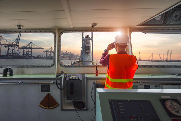 man on ship looking at sea