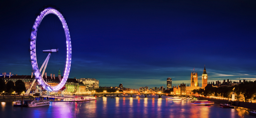 The huge London Eye is lit up in the evening and is by far the tallest structure visible on both sides of the Thames. Others include Big Ben and the Houses of Parliament.
