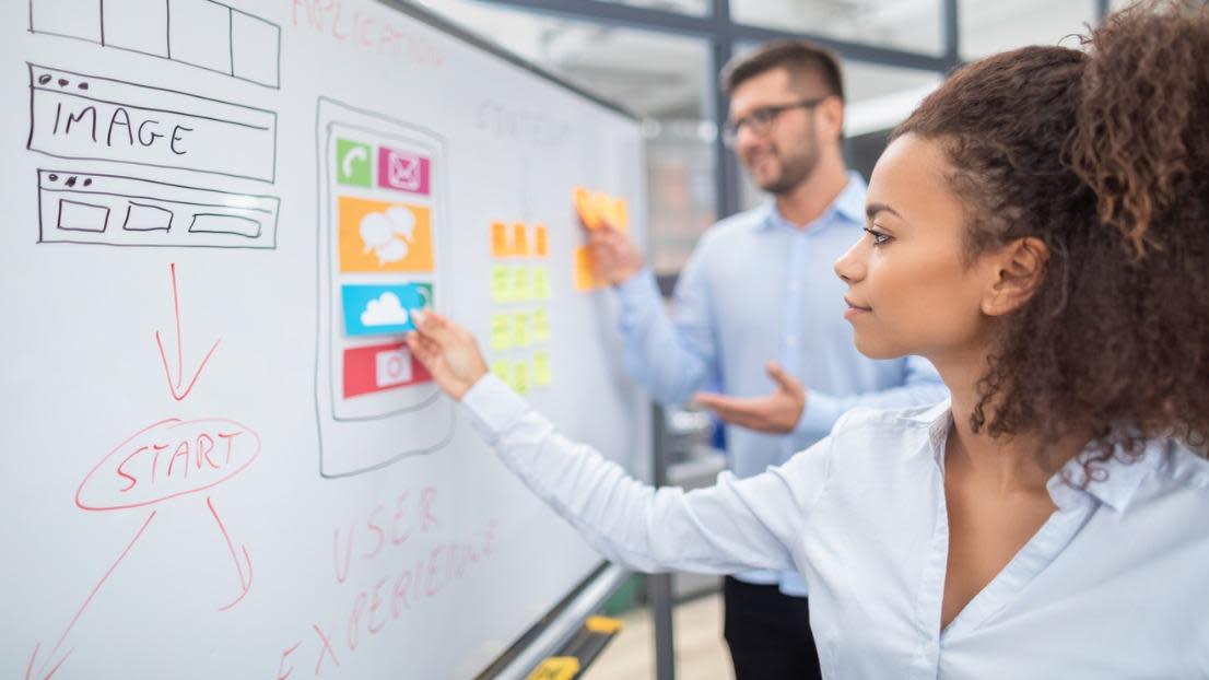 Designers drawing website development with marketing emphasis