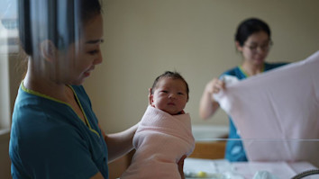Midwife holding a newborn baby