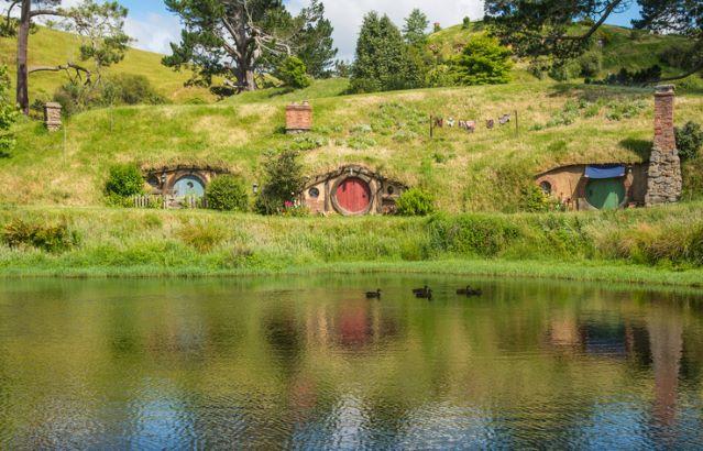 Scenery view of Hobbit holes at the waterfront in Hobbiton movie set in Matamata, New Zealand.