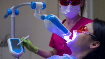 Close-up portrait of a female patient at dentist in the clinic