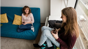 Mother and daughter relaxing in their living room