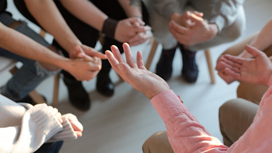 Close up of counsellor's hands explaining a problem to patients