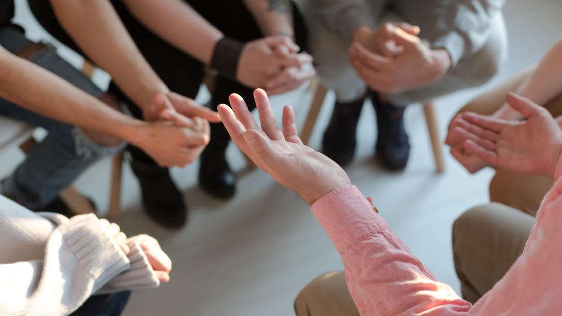 Close up of counsellor's hands explaining a problem to patients