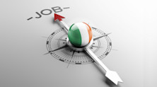 A compass with the flag of Ireland at its centre points towards the word 'job'