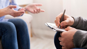 Woman talking while a psychologist takes notes