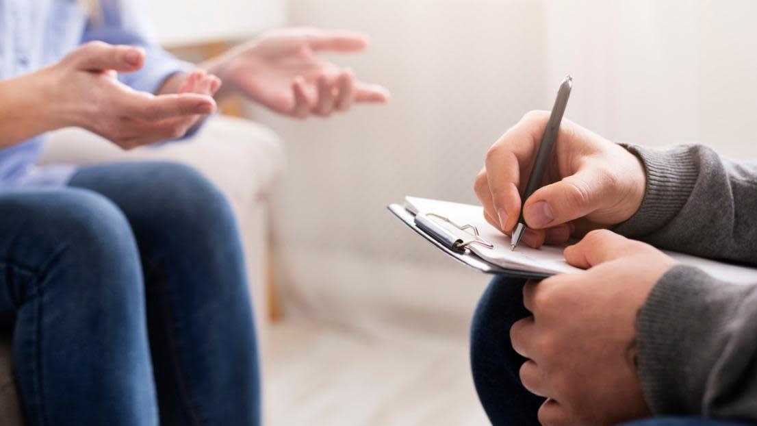 Woman talking while a psychologist takes notes