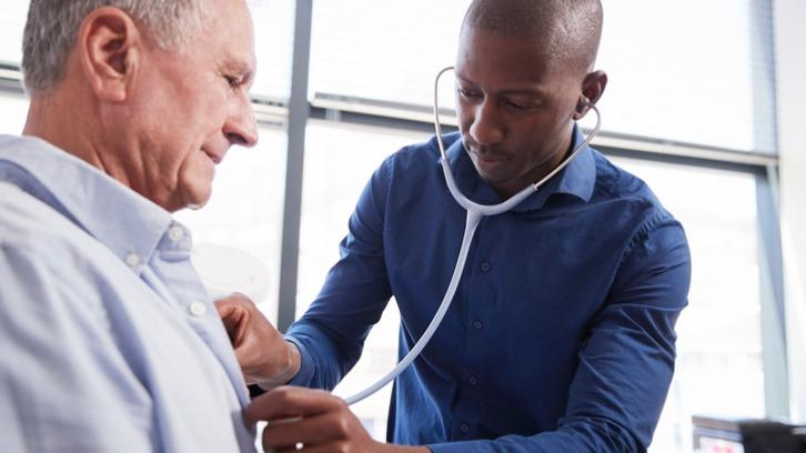 Doctor examining senior male patient
