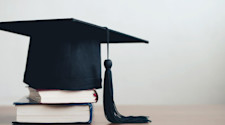 Graduation cap sat on top of two books
