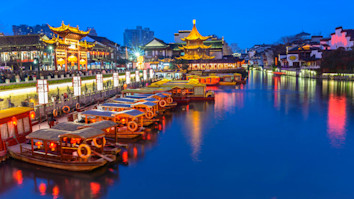 Nighttime on the Qinhuai River with boats and colourful lights