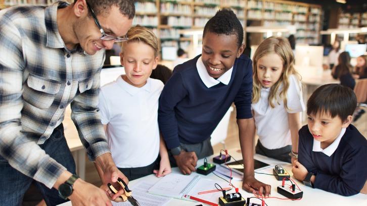 Teacher educating two students