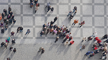 Bird's eye view of people in crowds on concrete ground