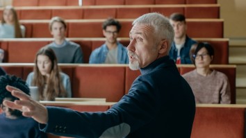 Camera facing class: professor gives a lecture to a classroom full of international students