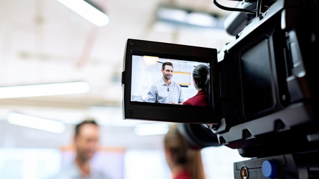  Business man and cameraman shooting video for broadcast