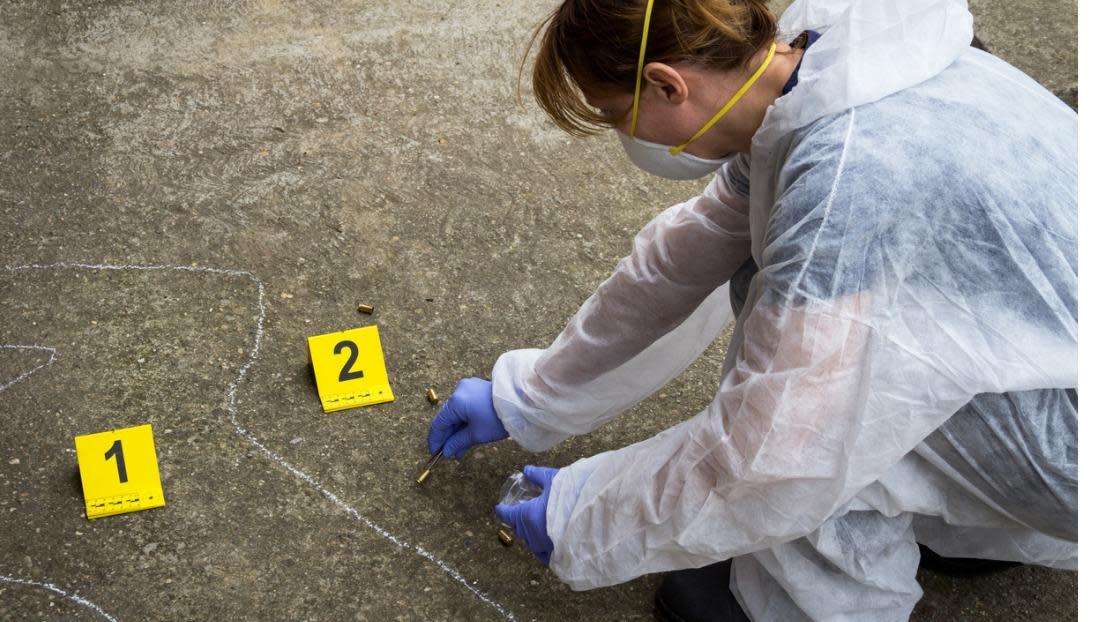 Forensic expert collects evidence at the crime scene