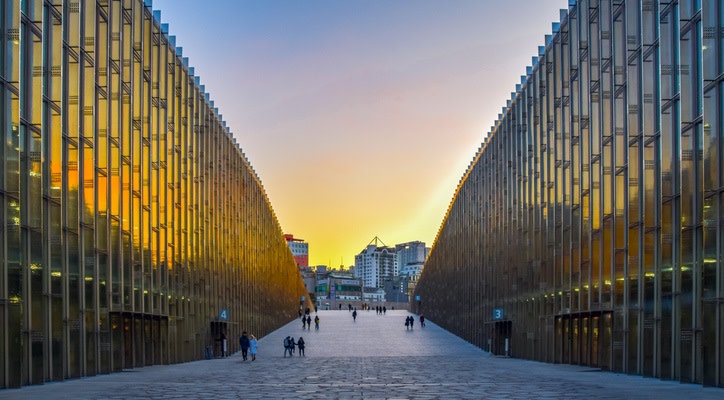 A wide walkway between two long glass buildings at Ewha Womans University in Seoul, South Korea