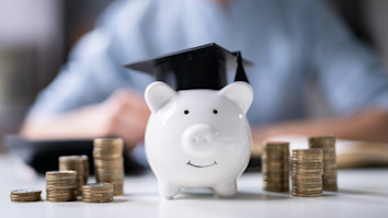 2025 tuition fee rise - stacked coins and piggy bank wearing a mortar board stock photo, iStock, AndreyPopov