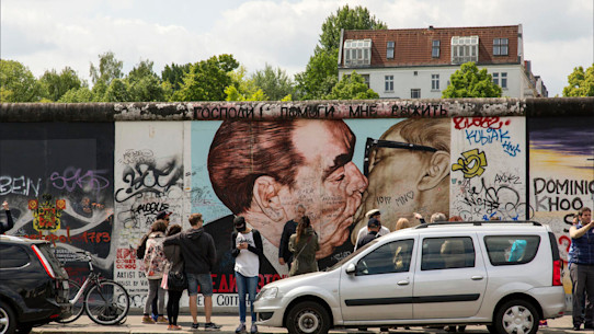 Tourists by the Berlin Wall East Side Gallery