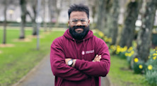 Abhishek Tilatiya stands and smiles in a park. He is wearing a University of Galway hoodie.